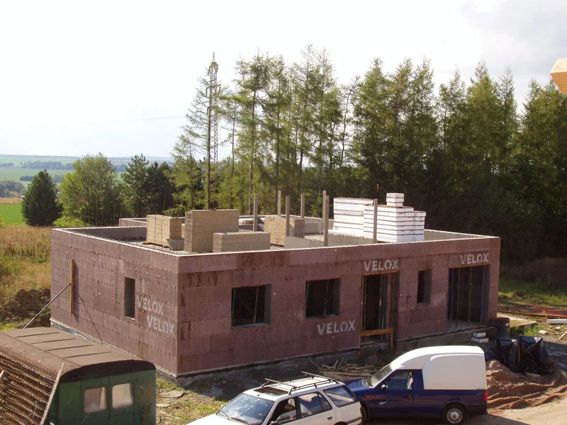 Začátek stavby vnitřních stěn podkroví, stohy desek Velox na stropě, 14. den
