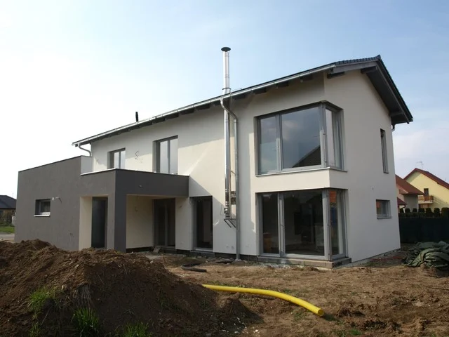 Dvoupodlažní dům ABELE s velkými prosklenými plochami a neupraveným terénem